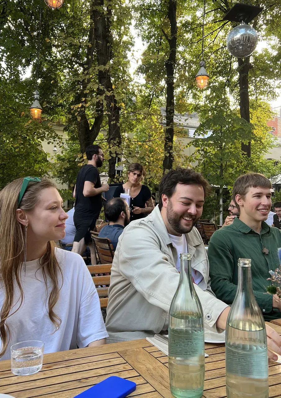 Popcorn teammates sharing drinks at an outdoor table