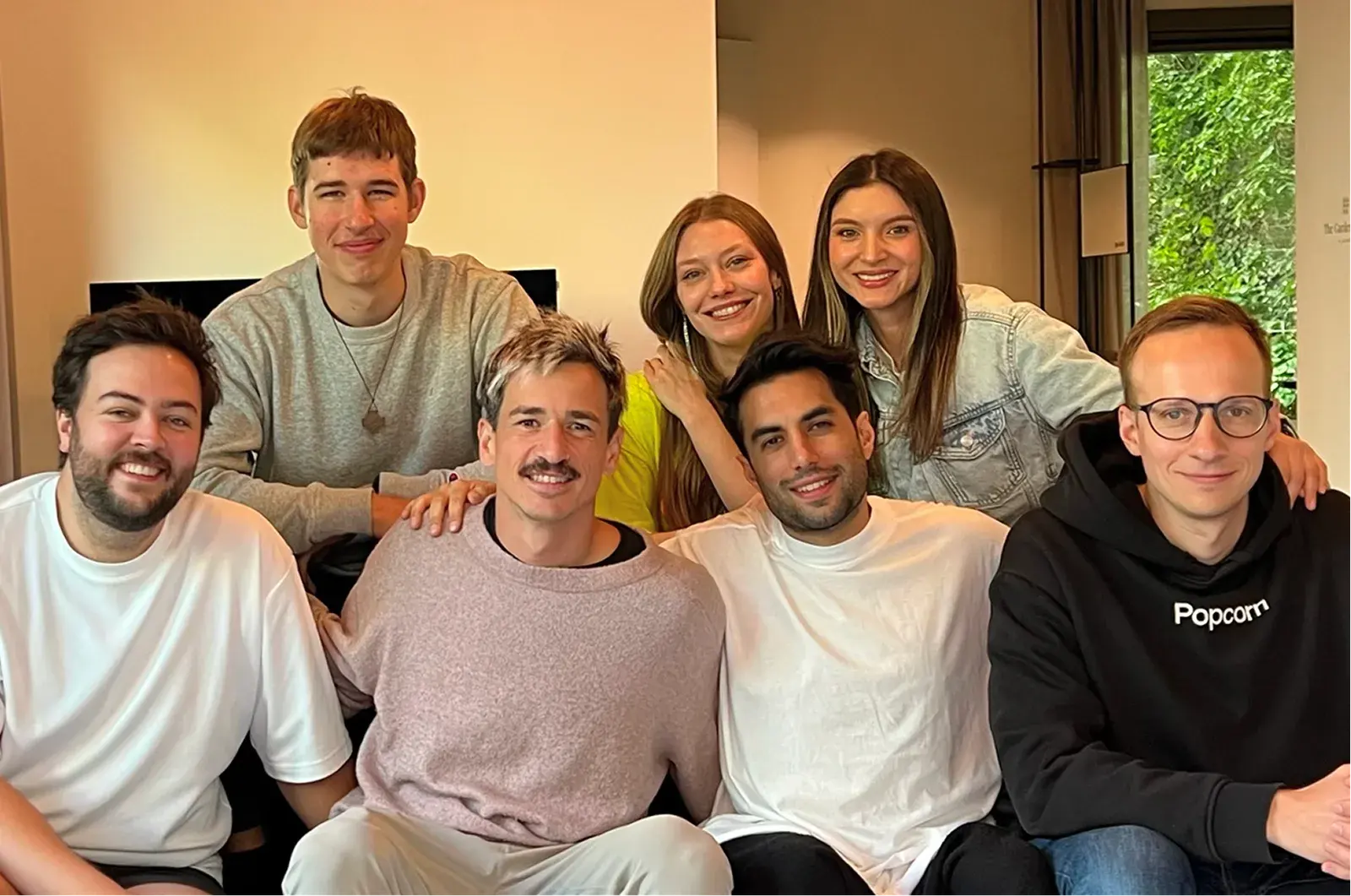 The Popcorn team gathered together on a couch